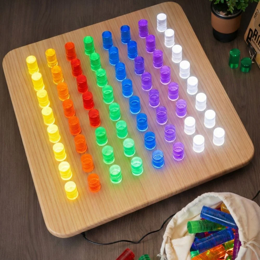 Child playing with a light-up sensory peg board placing acrylic color pegs