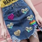Denim skirt decorated with reversible sequin fabric flip hearts
