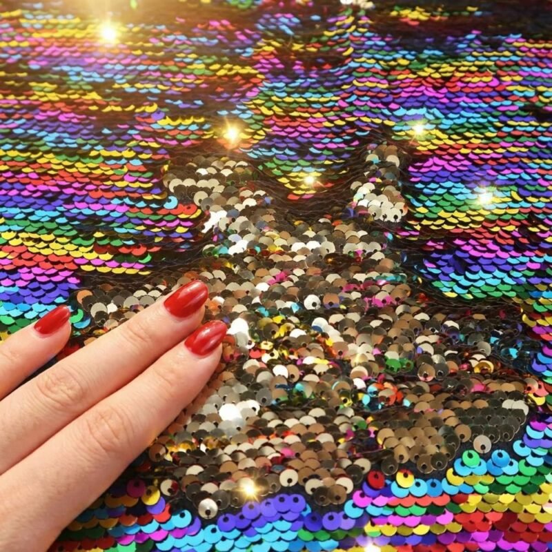Close-up of rainbow-to-gold reversible flip sequin fabric texture