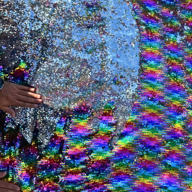 Hand flipping reversible sequin fabric from silver to rainbow